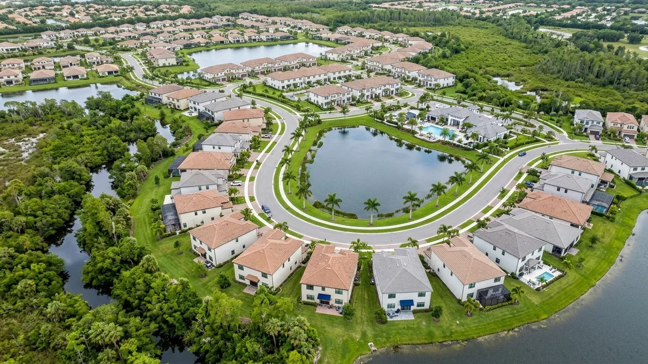 Aerial view of a new master-planned community in Estero Florida with curving streets, lakes, new homes of different sizes and preserve land
